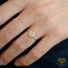 a woman's hand with a diamond ring on it