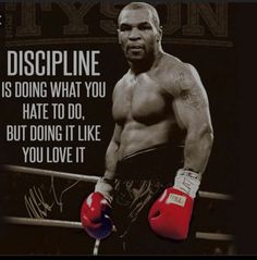 a man with boxing gloves standing in front of a sign that says, discipline is doing what you hate to do, but doing it like you love it