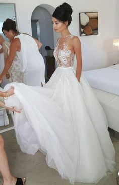 a woman in a wedding dress getting ready to walk down the aisle