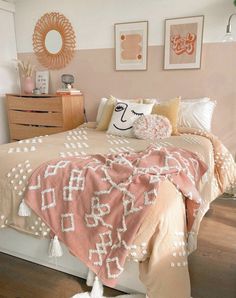 a bedroom with pink and white decor on the walls, bedding and dressers