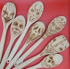 six wooden spoons with carved faces on them