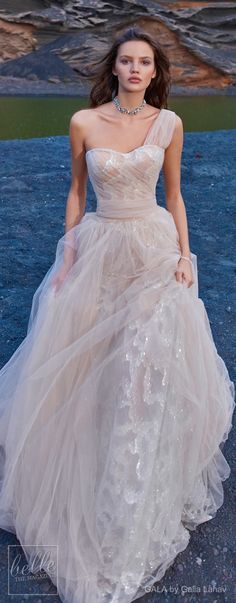 a woman in a wedding dress standing on the ground