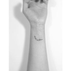 a person's arm with a small tattoo on it