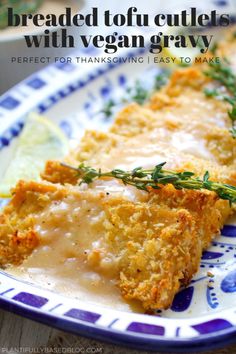 breaded tofu cutlets with vegan gravy on a blue and white plate