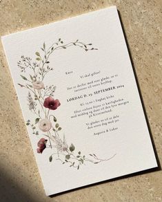 a wedding card with watercolor flowers on it