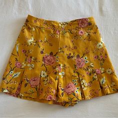 Mustard Yellow Floral Skirt With Front Pleats. 55% Linen And 45% Rayon Never Worn - No Tags Skirted Cotton Shorts For Summer, Cotton Skirted Shorts For Summer, Vacation Lined Skirt Shorts, Casual Floral Print Mini Shorts, Casual Mini Length Floral Print Shorts, Vacation Lined Short Skirt, Mini Floral Print Shorts For Day Out, Floral Print Mini Shorts For Day Out, Beach Mini Skirt Bottoms Pleated