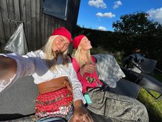 two beautiful young women sitting next to each other