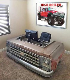 an old truck desk with a computer on it in front of a large poster that says high roller drive