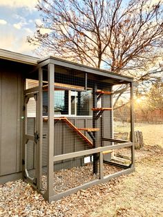 a small building with a metal fence around it's entrance and stairs leading up to the door