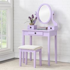 a purple vanity table with a mirror and stool