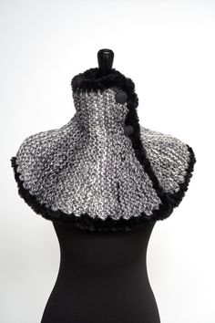 If you've been looking for something unique and are tired of wearing scarves in a cold weather, then this is a great alternative for you. You can wear this capelet under or over your favorite coat or even with a dress for a unique look. Just look at the pictures to get some ideas how you can wear this unique garment. I knitted this cowl capelet from a soft wool/acrylic/alpaca yarn and embellished with faux fur trim and three buttons. Measurements: from neck to bottom - approx. 13" (34 cm) More capelets cowls here - https://www.etsy.com/shop/KnitsomeStudio?ref=seller-platform-mcnav§ion_id=10514179 and here - https://www.etsy.com/shop/KnitsomeStudio?ref=seller-platform-mcnav§ion_id=25373486 Don't forget to check out my other items! There are many more in my shop -- http://www.etsy.com/shop/k Black Winter Scarves, Warm Black Winter Scarf, Black Winter Scarves For Cold Weather, Black Scarves For Cold Weather, One Size, Black Knitted Scarves For Winter, Black Knitted Winter Scarf, Black Knitted Scarf For Winter, Winter Knit Scarves, Knit Winter Scarves