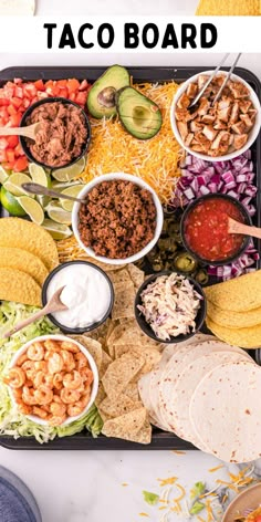 a tray filled with taco salads, tortilla chips and guacamole