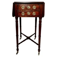 an antique wooden table with brass knobs on the top and bottom drawered drawers