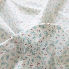 the fabric is white with blue and red flowers on it