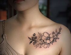 a woman with a flower tattoo on her chest