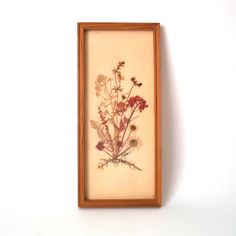 a framed floral print hangs on the wall