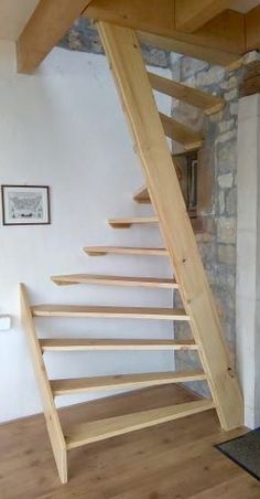 a wooden stair case in the corner of a room