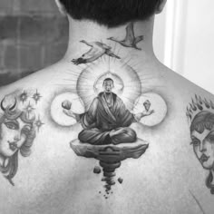 the back of a man's neck with tattoos on it and an image of buddha