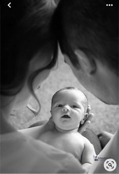 a woman holding a baby in her arms