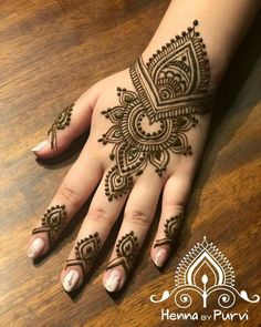 henna tattoo on the palm of a woman's hand