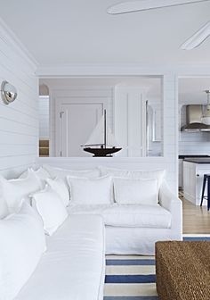 a living room filled with furniture and white walls