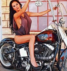 a beautiful woman sitting on top of a motorcycle