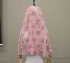 a mannequin is adorned with pink roses