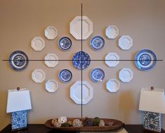 the wall is decorated with blue and white plates