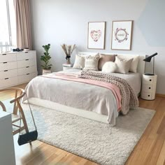 a bedroom with a bed, dresser and two pictures on the wall above it's headboard