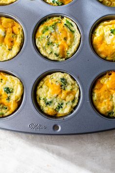 a muffin tin filled with different types of breakfast foods on top of a table