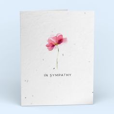 a card with the words in sympathy written on it and a single pink poppy flower