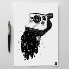 a black and white drawing of a polaroid camera on top of a piece of paper