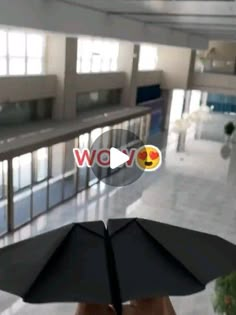 someone holding an umbrella in the middle of a building