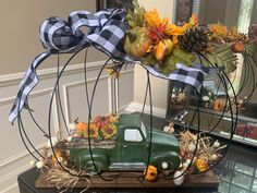 a green truck is decorated with fall decorations