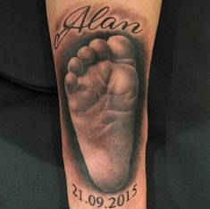 a black and white photo of a baby's foot with the name alon on it