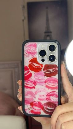 a woman is holding up her phone case with lipstick on it and the cover has been painted