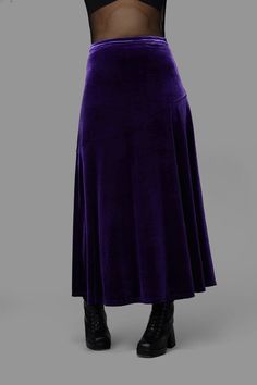 Elevate your evening attire with this stunning Formal Maxi Skirt by Black Friday. This elegant piece features a fitted waistband that hugs your silhouette beautifully, while the asymmetrical design line across the front adds a touch of modern sophistication. Crafted from luxurious stretch velvet, the draped fabric flows gracefully, creating an enchanting movement as you walk.With a convenient zip closure at the side seam, this maxi skirt is as practical as it is stylish. Fabric & Care:Material: 100% Polyester VelourCare Instructions:Cold Machine WashDo Not Bleach or SoakDo Not Wring or SpinDo Not Tumble DryCool Iron on Reverse if Required Purple Velvet Skirt Outfit, Whimsigoth Skirt, Formal Maxi Skirt, Whimsigoth Fashion, Alternative Fashion Indie, Avengers Dr, Whimsical Clothing, Whimsical Gothic, Kids Scrubs