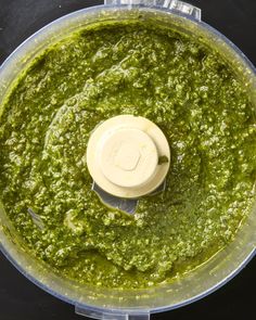 a food processor filled with pesto sauce