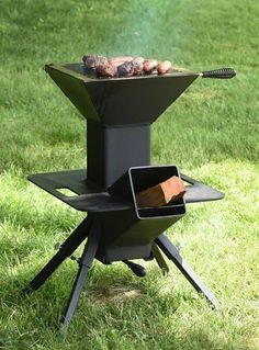 an outdoor bbq grill in the grass