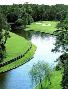 a river running through a lush green golf course