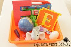 an orange tray filled with toys on top of a table