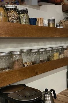 two wooden shelves filled with jars and spices