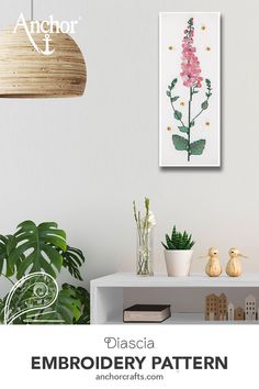 a white table with some plants on top of it and the words diasica embroidery pattern above it