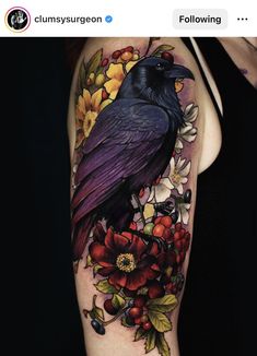 a black bird sitting on top of flowers