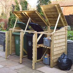 an outdoor storage area with trash cans and bins