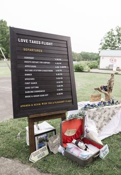 a sign that says love takes flight next to an assortment of items on the ground