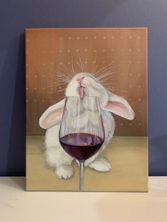 a painting of a rabbit holding a glass of wine with its nose sticking out while sitting on a table