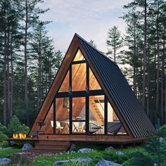 a - frame cabin in the woods is lit up at night