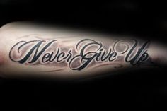 a man's arm with the words never give up on it