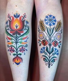 the legs are decorated with colorful flowers and leaves on both side of their thighs,